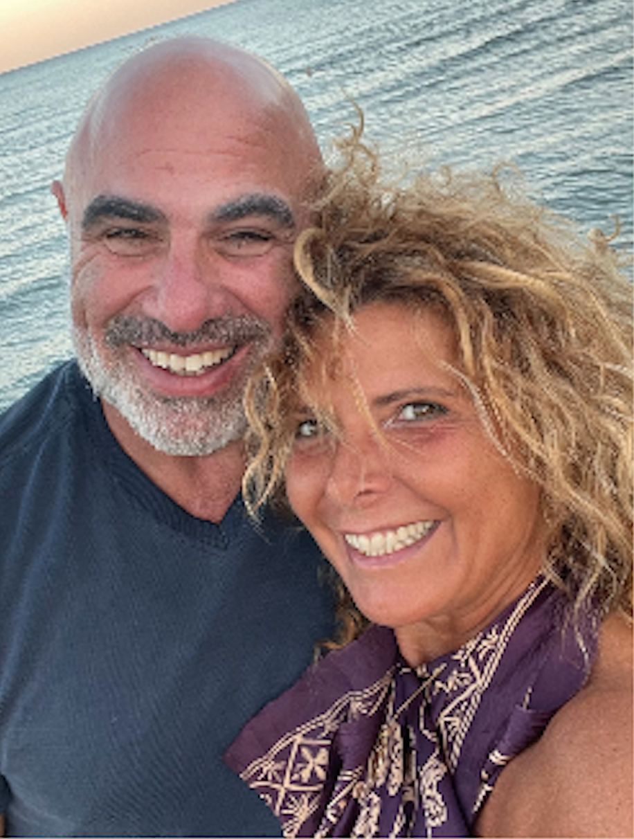 Peter and Eva together, smiling by the sea