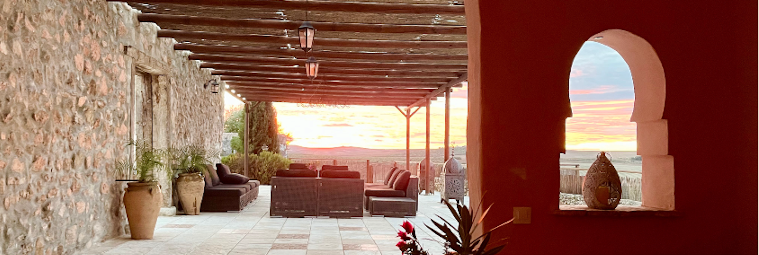 Terrace with terracotta arches and sunset view