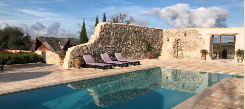 Swimming pool with stone walls at Cortijo San Jose